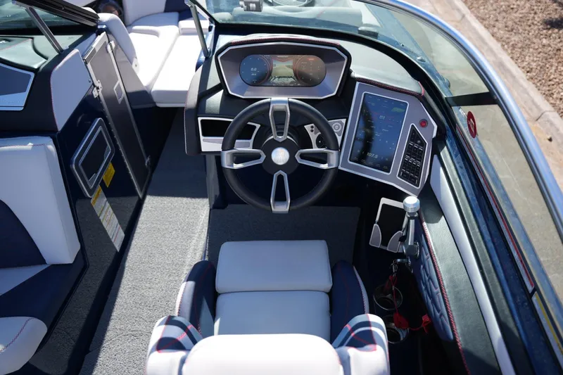 Slide: The Image of 2019 MasterCraft X24 boat cockpit with modern steering and digital controls. - 14