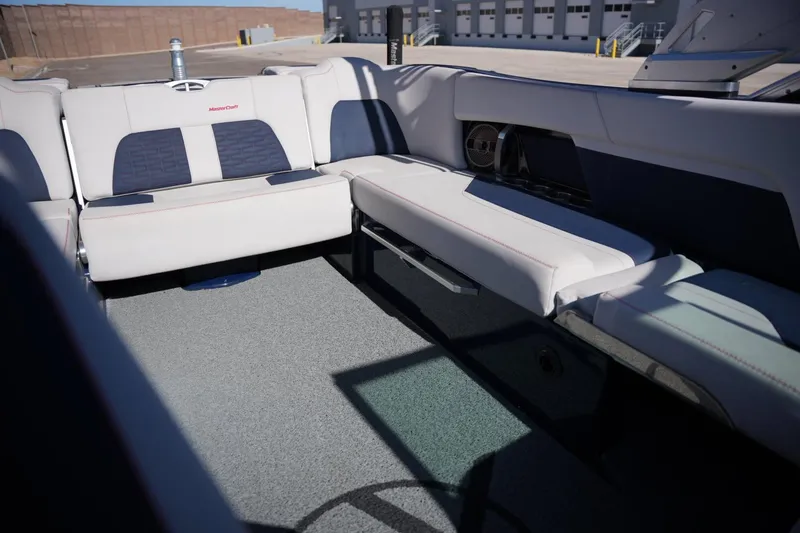 Slide: The Image of Interior seating of a 2019 MasterCraft X24 boat, featuring white and blue upholstery. - 15