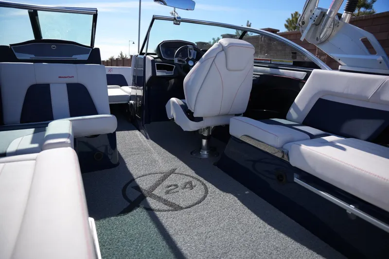 Slide: The Image of 2019 MasterCraft X24 boat interior with luxurious seating and modern dashboard. - 17