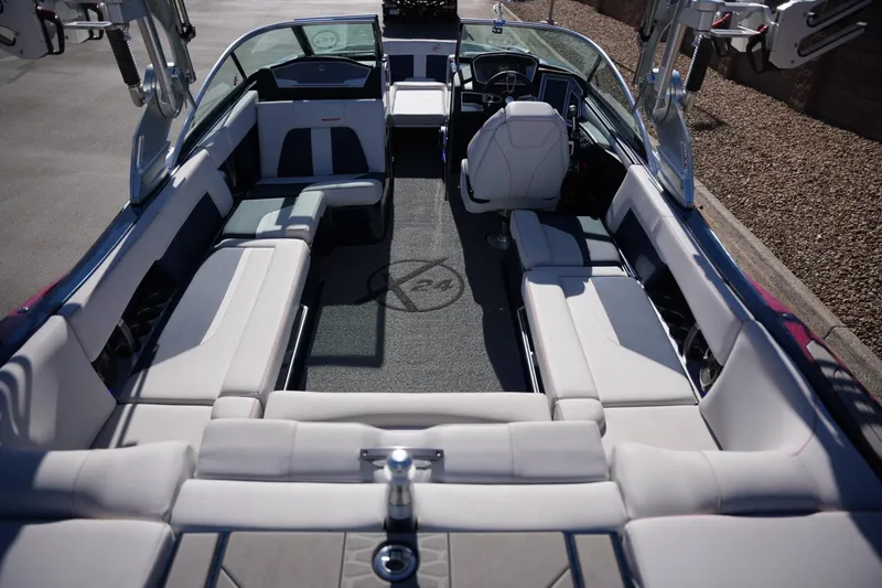 Slide: The Image of 2019 MasterCraft X24 boat interior with spacious seating and modern dashboard. - 19