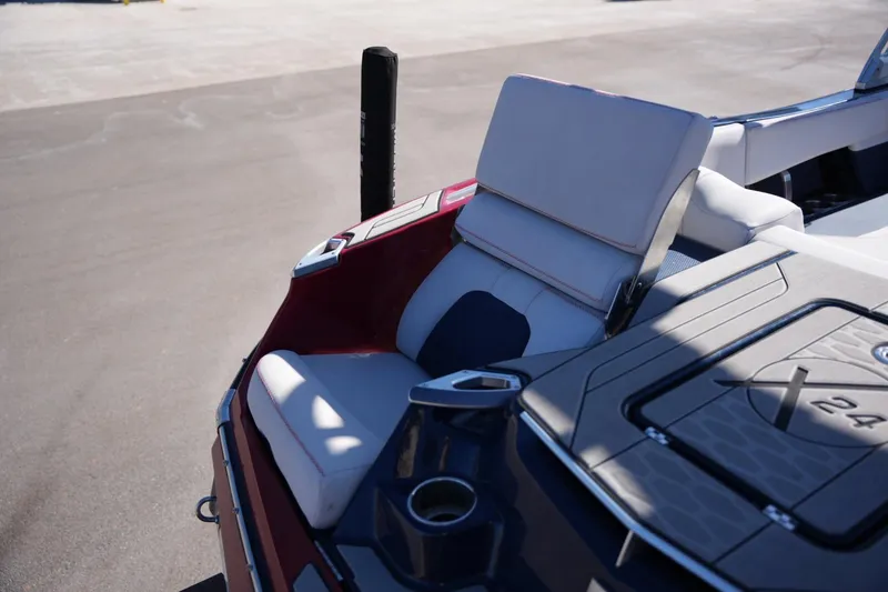 Slide: The Image of 2019 MasterCraft X24 boat interior with plush seating and cup holders. - 21