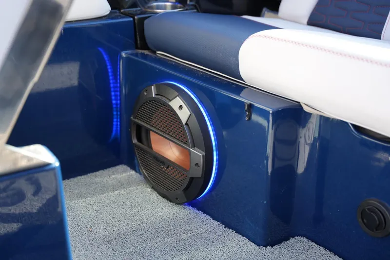 Slide: The Image of 2019 MasterCraft X24 boat interior with illuminated speaker and blue seating. - 23