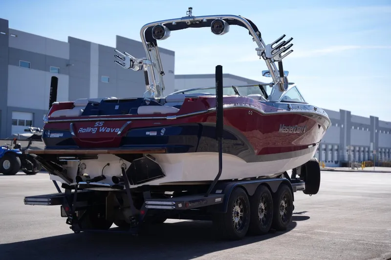 Slide: The Image of 2019 MasterCraft X24 boat on trailer, parked outdoors. - 4