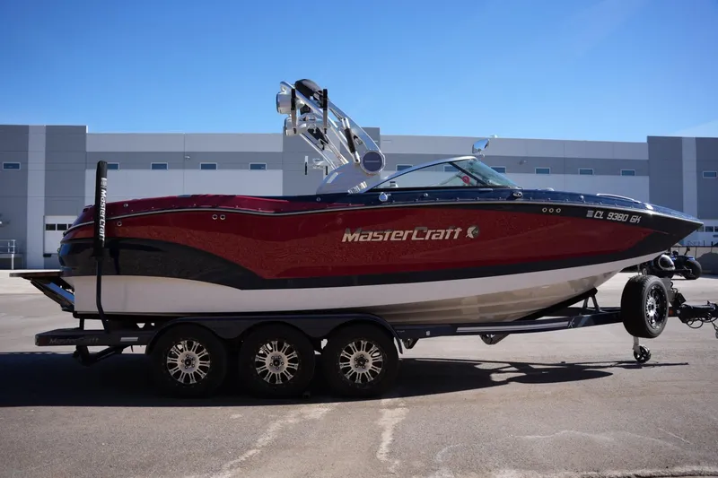 Slide: The Image of 2019 MasterCraft X24 boat on trailer, parked outside industrial building. - 5