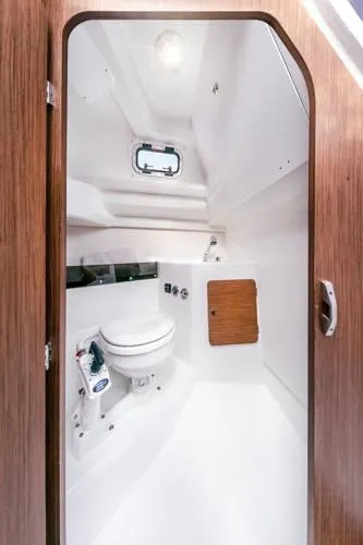 Slide: The Image of 2024 Beneteau Antares 8 V2 boat bathroom interior with modern fixtures and wooden accents. - 10