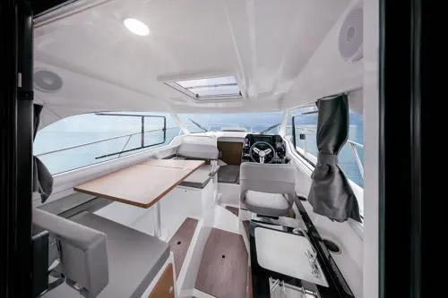 Slide: The Image of Interior of 2024 Beneteau Antares 8 V2, featuring modern seating and navigation area. - 9