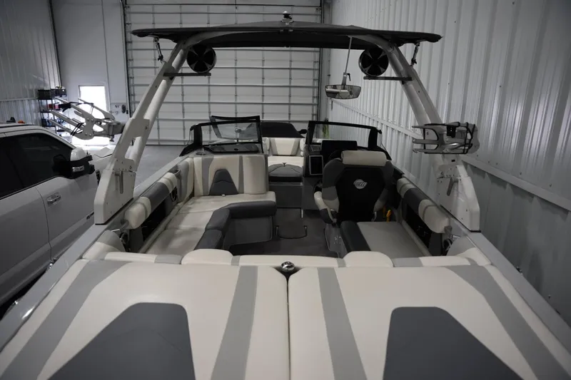 Slide: The Image of 2020 Malibu Wakesetter 21 VLX interior with seating and wakeboard tower in a garage. - 15