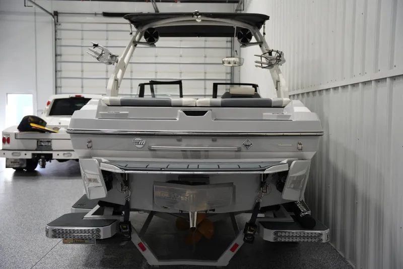 Slide: The Image of 2020 Malibu Wakesetter 21 VLX boat in a garage, rear view. - 3