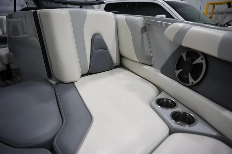 Slide: The Image of 2020 Malibu Wakesetter 21 VLX interior with gray and white seating, cup holders, and speaker. - 7