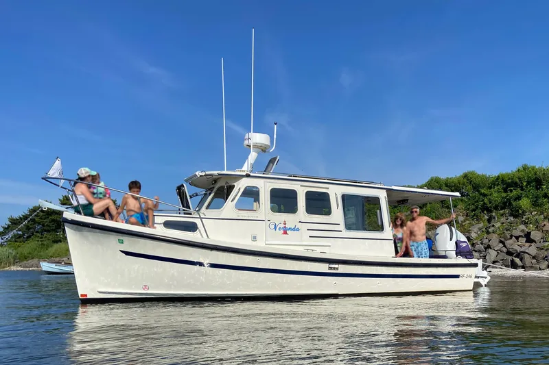 The Image of 2007 Rosborough RF-246 Sedan Cruiser with people enjoying a sunny day on the water. - 0