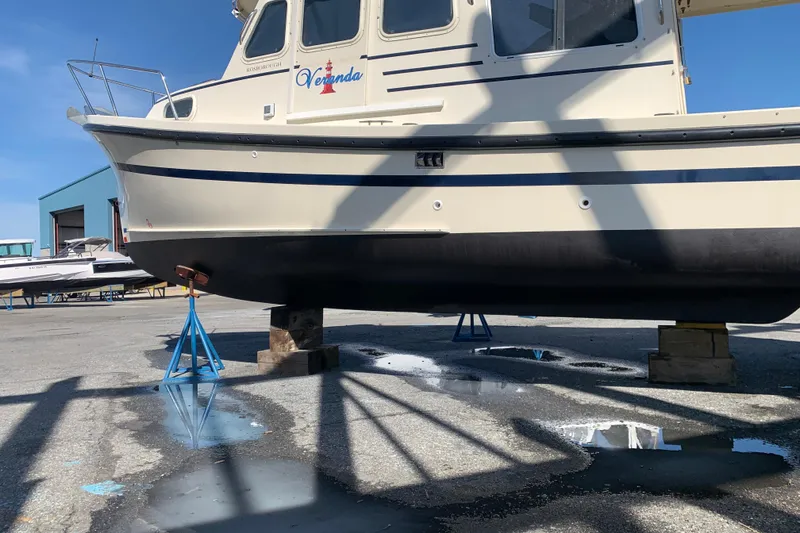 Slide: The Image of 2007 Rosborough RF-246 Sedan Cruiser on stands, side view, in a boatyard. - 1