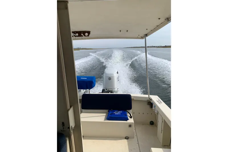 Slide: The Image of 2007 Rosborough RF-246 Sedan Cruiser on water, view from cabin showing wake and outboard motor. - 11