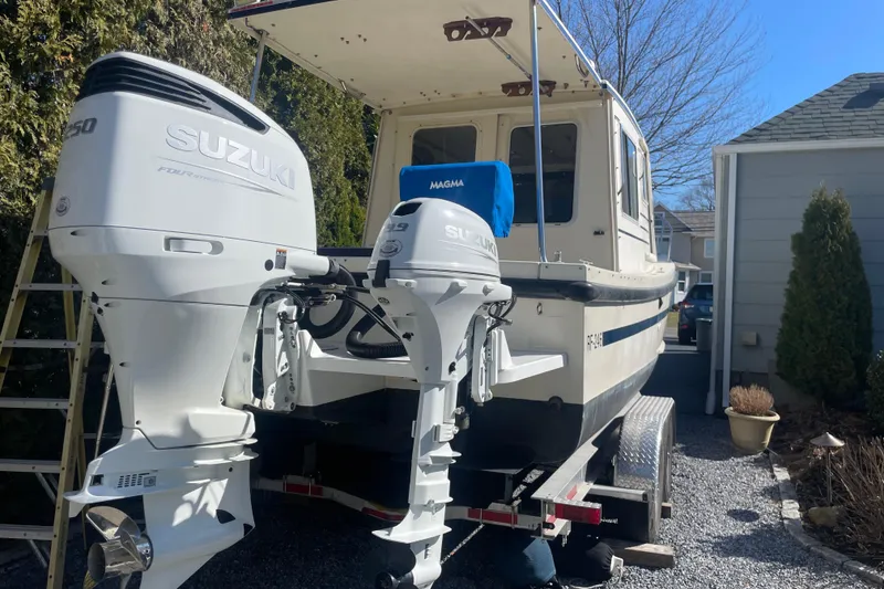 Slide: The Image of 2007 Rosborough RF-246 Sedan Cruiser with Suzuki outboard motors on a trailer. - 12