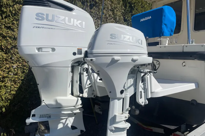 Slide: The Image of Twin Suzuki outboard motors on a 2007 Rosborough RF-246 Sedan Cruiser. - 13