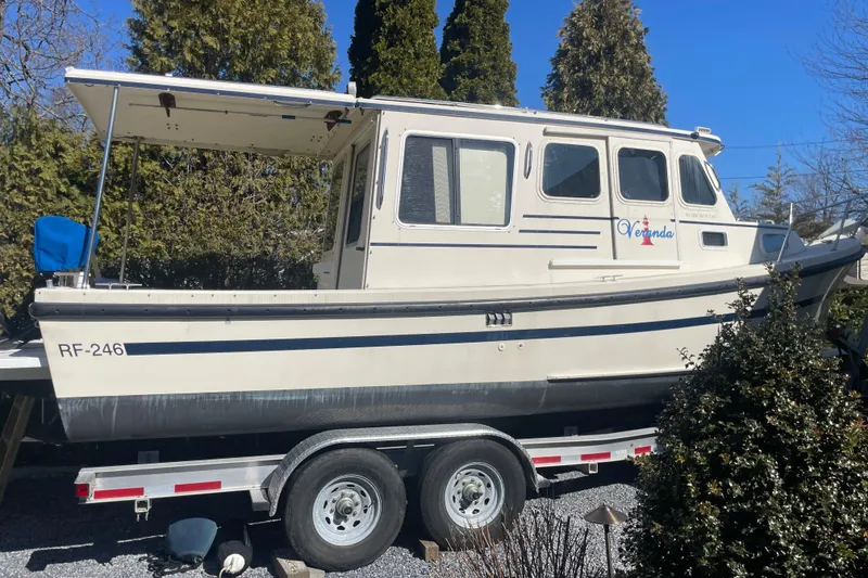Slide: The Image of 2007 Rosborough RF-246 Sedan Cruiser on trailer, surrounded by trees. - 14