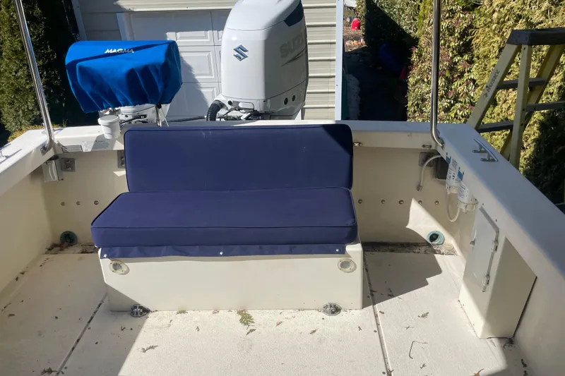 Slide: The Image of 2007 Rosborough RF-246 Sedan Cruiser with blue cushioned seating and Suzuki outboard motor. - 15