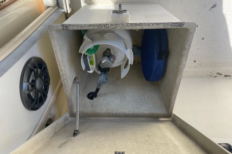 Slide: The Image of Storage compartment on 2007 Rosborough RF-246 Sedan Cruiser with propane tank and cleaning supplies. - 16