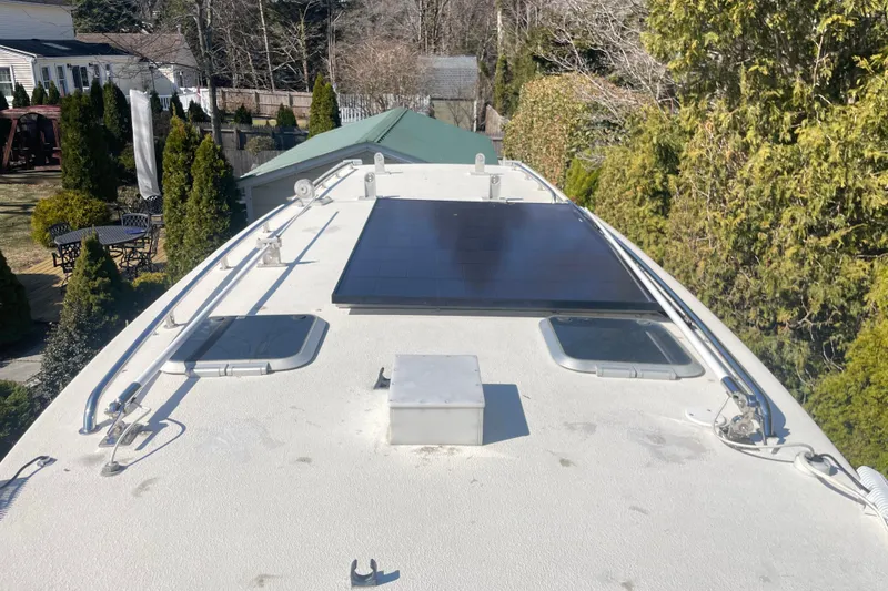 Slide: The Image of 2007 Rosborough RF-246 Sedan Cruiser roof with solar panel and hatches, surrounded by greenery. - 18