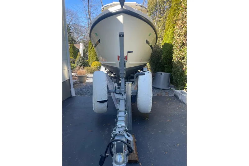 Slide: The Image of 2007 Rosborough RF-246 Sedan Cruiser on trailer in driveway, surrounded by greenery. - 22