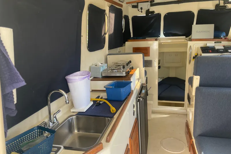 Slide: The Image of 2007 Rosborough RF-246 Sedan Cruiser interior with kitchenette and seating area. - 25