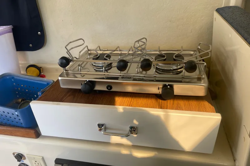 Slide: The Image of Stove inside 2007 Rosborough RF-246 Sedan Cruiser, featuring a compact kitchen setup. - 28