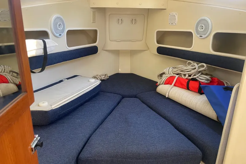 Slide: The Image of 2007 Rosborough RF-246 Sedan Cruiser cabin interior with blue cushions and nautical equipment. - 29