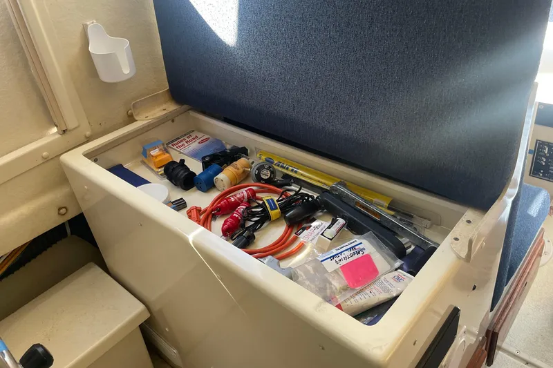 Slide: The Image of Storage compartment in a 2007 Rosborough RF-246 Sedan Cruiser with various tools and supplies. - 30