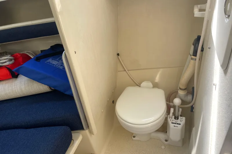 Slide: The Image of 2007 Rosborough RF-246 Sedan Cruiser interior with marine toilet and storage area. - 32