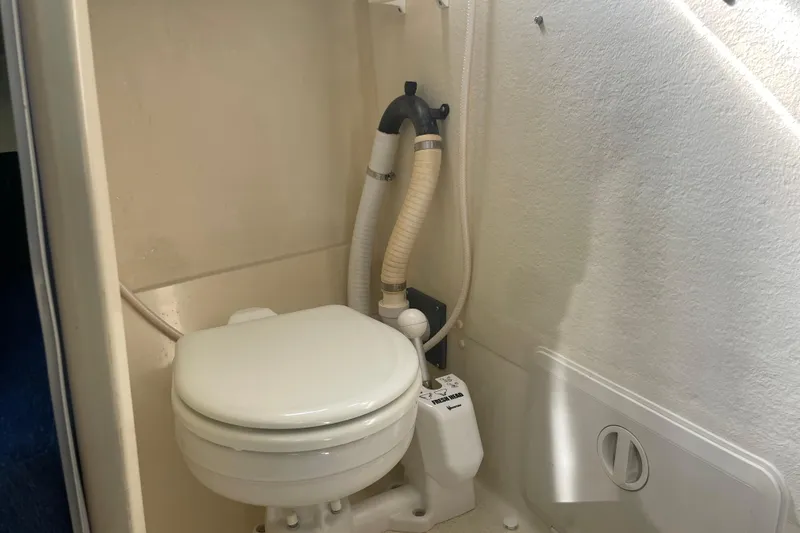 Slide: The Image of 2007 Rosborough RF-246 Sedan Cruiser marine toilet in compact bathroom setting. - 33