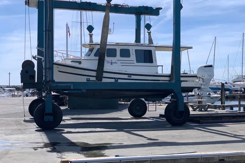 Slide: The Image of 2007 Rosborough RF-246 Sedan Cruiser on a boat lift at a marina. - 4