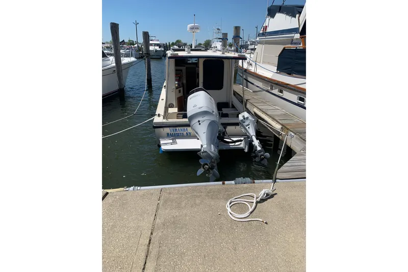 Slide: The Image of 2007 Rosborough RF-246 Sedan Cruiser docked at marina with twin outboard motors. - 5