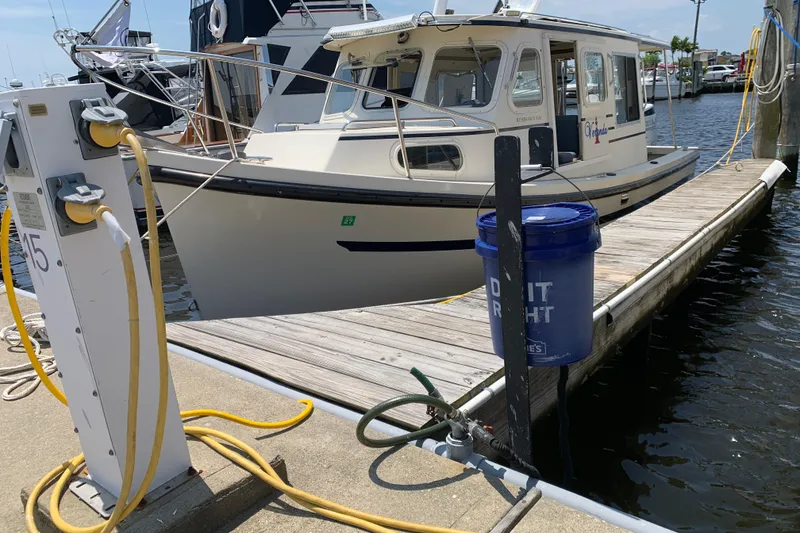 Slide: The Image of 2007 Rosborough RF-246 Sedan Cruiser docked at marina with utility connections. - 8