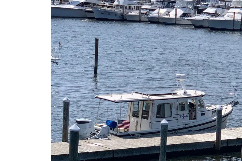 Slide: The Image of 2007 Rosborough RF-246 Sedan Cruiser docked at a marina with other boats. - 9