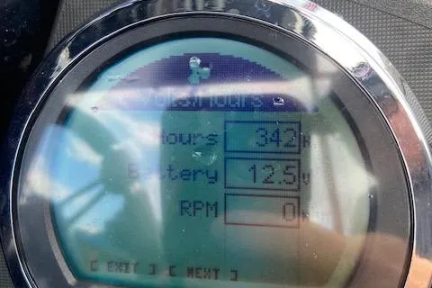 Slide: The Image of Close-up of a Ranger 520C 2014 dashboard showing 342 hours and 12.5V battery. - 4