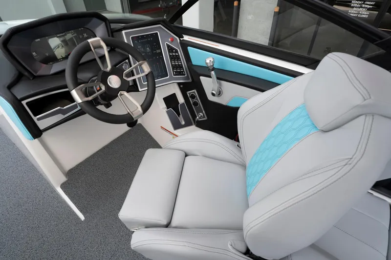 Slide: The Image of 2022 MasterCraft XT22 boat interior with modern steering and control panel. - 10