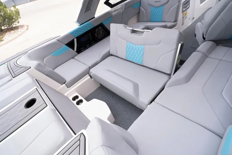 Slide: The Image of 2022 MasterCraft XT22 boat interior with modern seating and blue accents. - 12