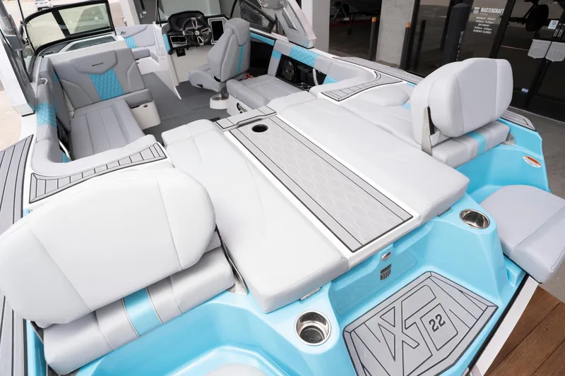 Slide: The Image of 2022 MasterCraft XT22 boat interior with luxurious seating and modern dashboard. - 14