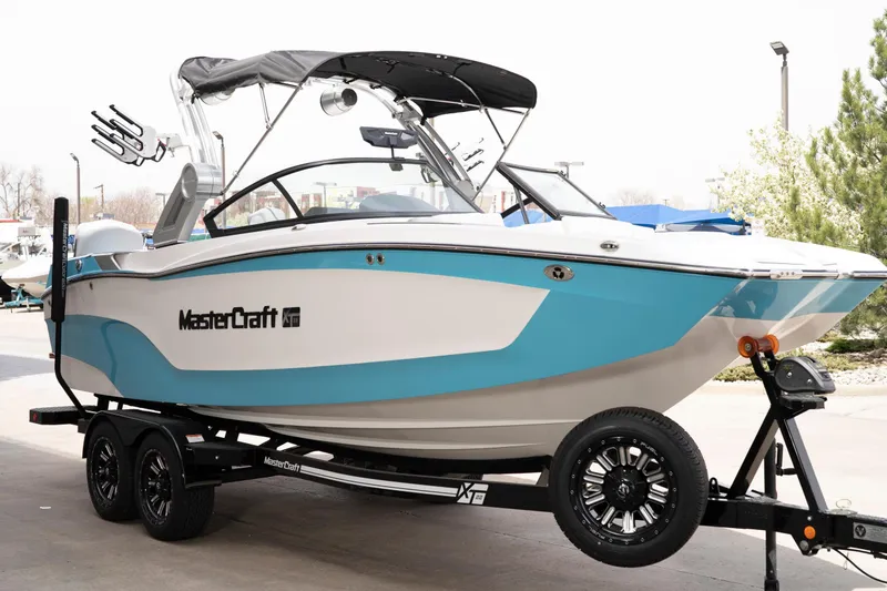 Slide: The Image of 2022 MasterCraft XT22 boat on trailer, featuring sleek design and vibrant blue accents. - 5