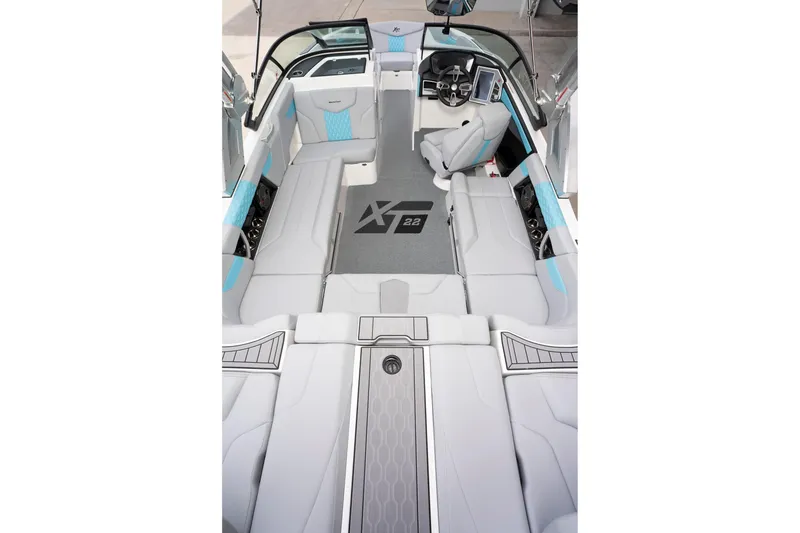 Slide: The Image of 2022 MasterCraft XT22 boat interior with sleek seating and modern dashboard design. - 7