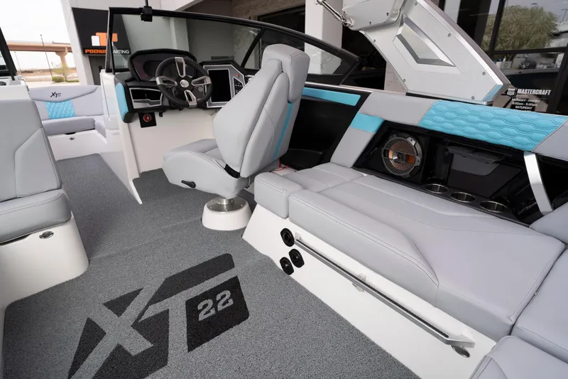 Slide: The Image of 2022 MasterCraft XT22 boat interior with modern seating and steering wheel design. - 8