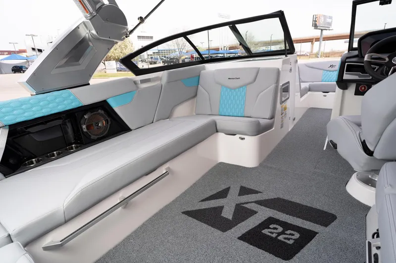 Slide: The Image of 2022 MasterCraft XT22 boat interior with modern seating and stylish design. - 9
