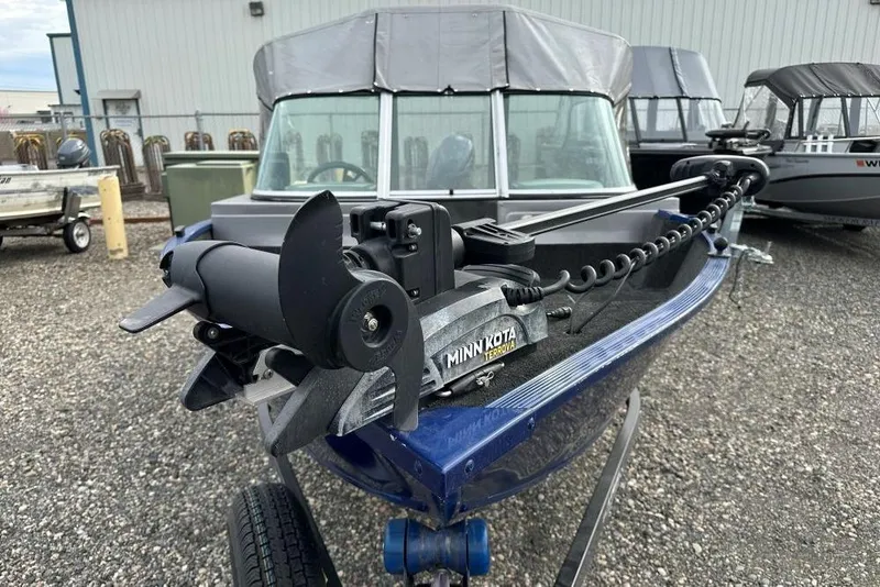 Slide: The Image of 2014 Lowe Fishing Machine 165WT Pro with Minn Kota Terrova motor in a boatyard. - 3