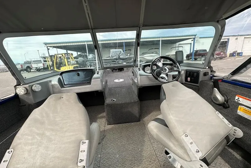 Slide: The Image of 2014 Lowe Fishing Machine 165WT Pro interior with steering wheel and seating. - 5