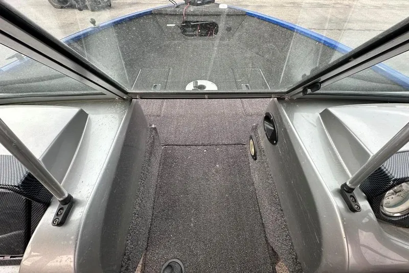 Slide: The Image of 2014 Lowe Fishing Machine 165WT Pro interior with windshield and carpeted deck. - 6