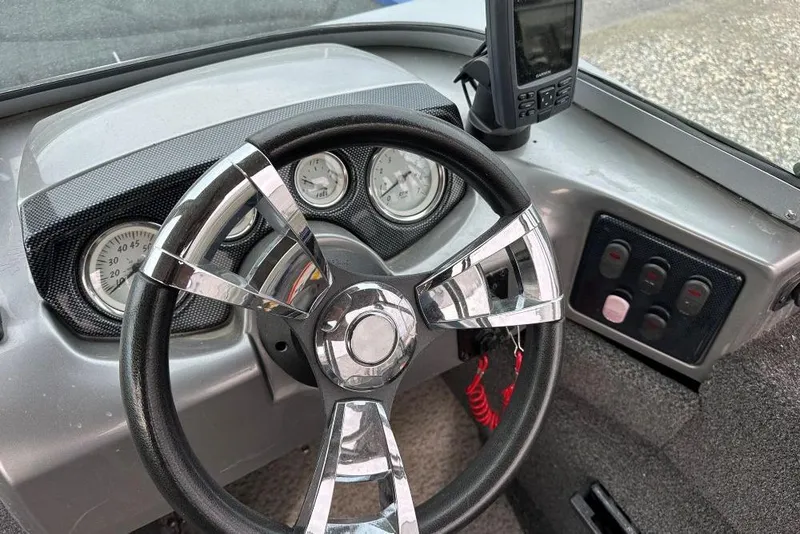 Slide: The Image of Steering wheel and dashboard of 2014 Lowe Fishing Machine 165WT Pro boat. - 8