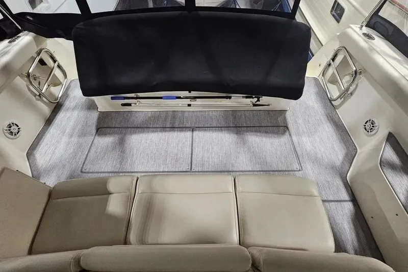 Slide: The Image of 1995 Tiara Yachts 4000 Express interior with beige seating and carpeted flooring. - 10