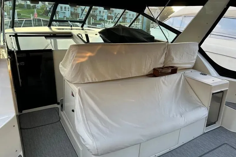 Slide: The Image of 1995 Tiara Yachts 4000 Express interior with cushioned seating and modern design. - 11