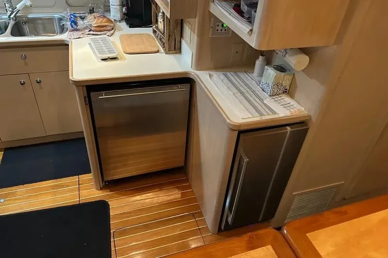 Slide: The Image of 1995 Tiara Yachts 4000 Express kitchen with wooden flooring and modern appliances. - 15