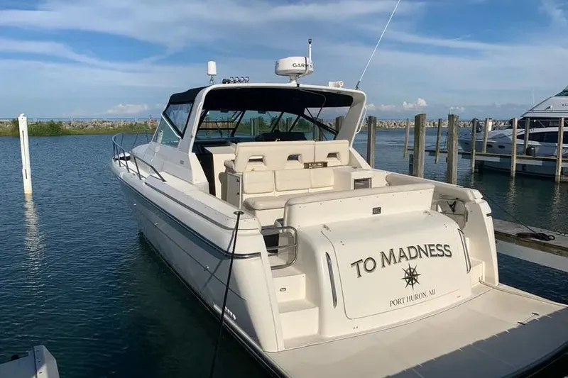 Slide: The Image of 1995 Tiara Yachts 4000 Express docked, rear view with "To Madness" name visible. - 21