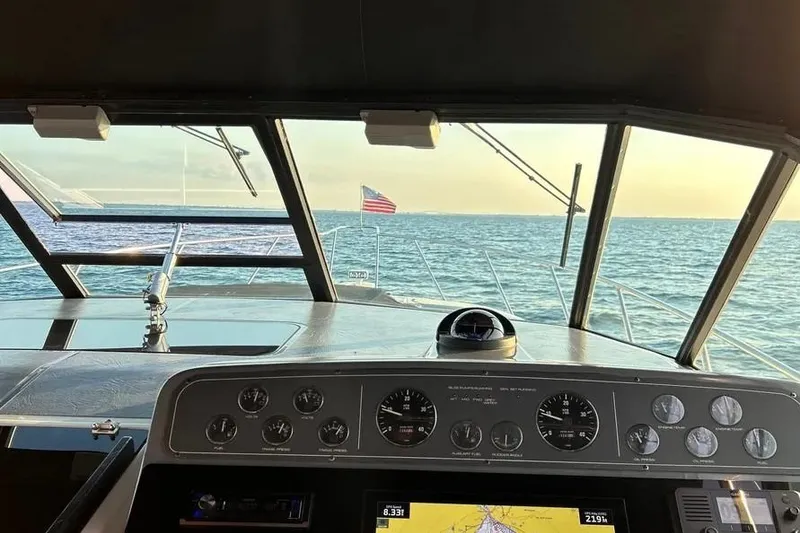 Slide: The Image of Cockpit view from a 1995 Tiara Yachts 4000 Express, overlooking the ocean with an American flag. - 28